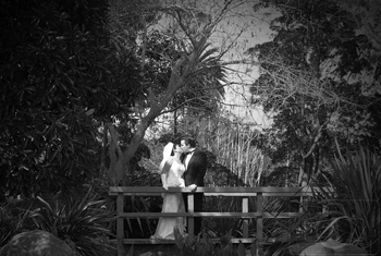bride and groom kiss on the garden